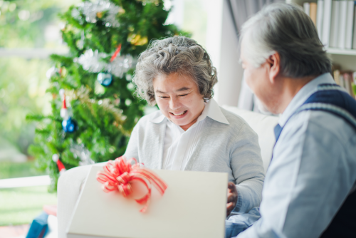 old people opening a gift